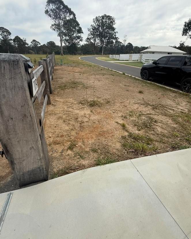A Vacant, Dirt Lot Next to A Wooden Fence, Sidewalk — East Coast Hydroseeding in Coffs Harbour, NSW