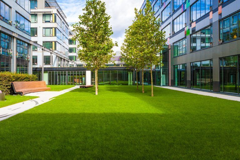 Yellow Water Tanker on A Road, with Construction Equipment — East Coast Hydroseeding in Wauchope, NSW