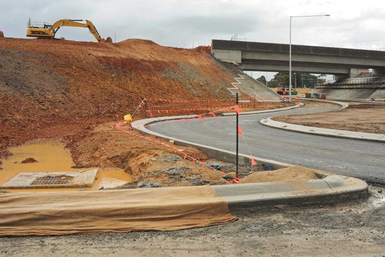 Road Construction Site; Paved Road Curves Under a Bridge — East Coast Hydroseeding in Cooperabung, NSW