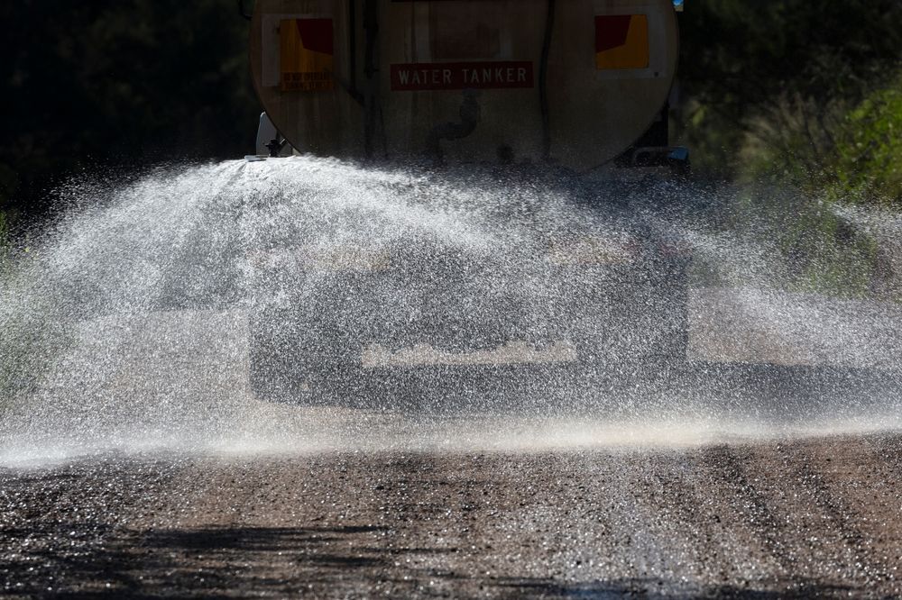 Water Truck Spraying Water onto A Road, Creating a Large Arc of Droplets — East Coast Hydroseeding in Forster, NSW