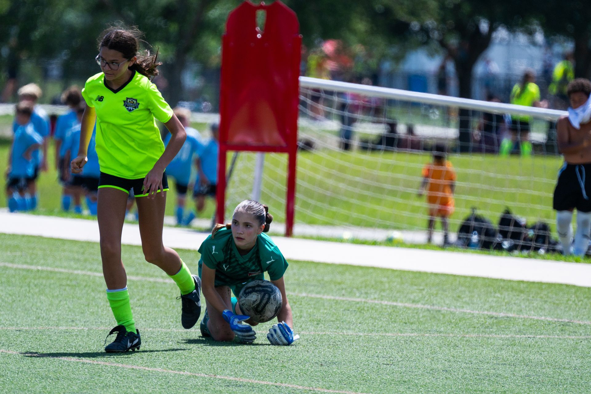 Girl soccer player scoring a goal for Space Coast United Soccer