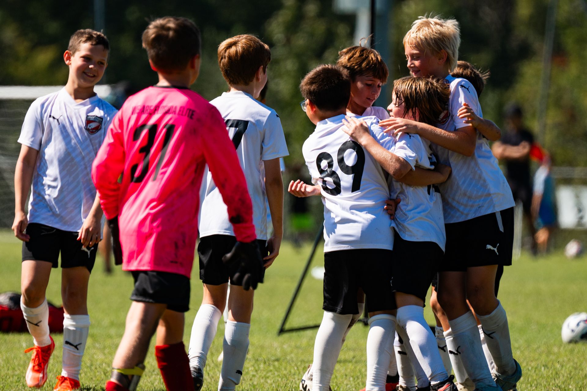 Space Coast United Soccer soccer team in a huddle with coaches