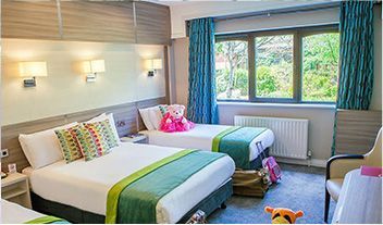 A hotel room with two beds