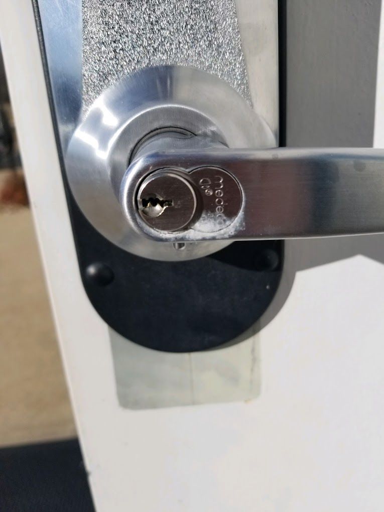A close up of a door handle with a key in it.