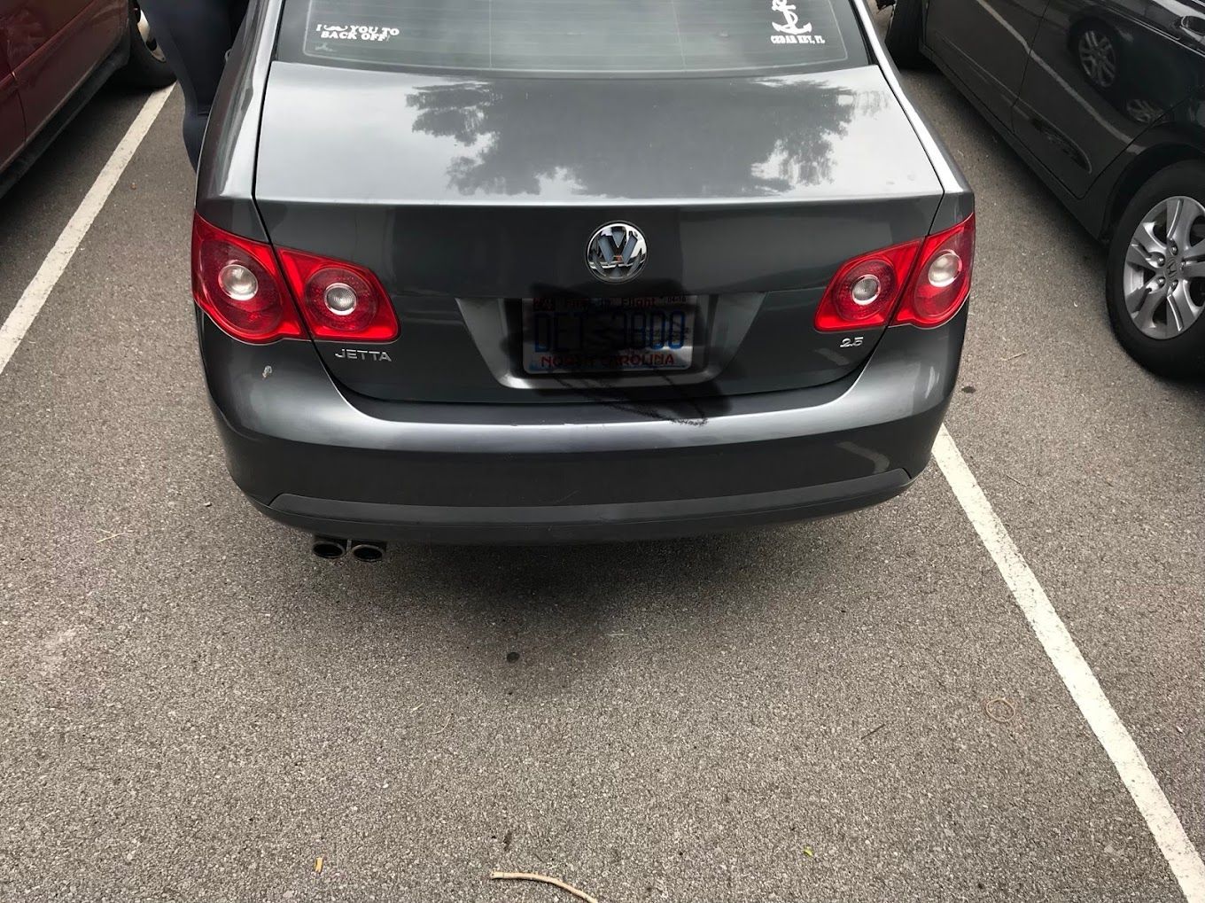 A volkswagen jetta is parked in a parking lot.