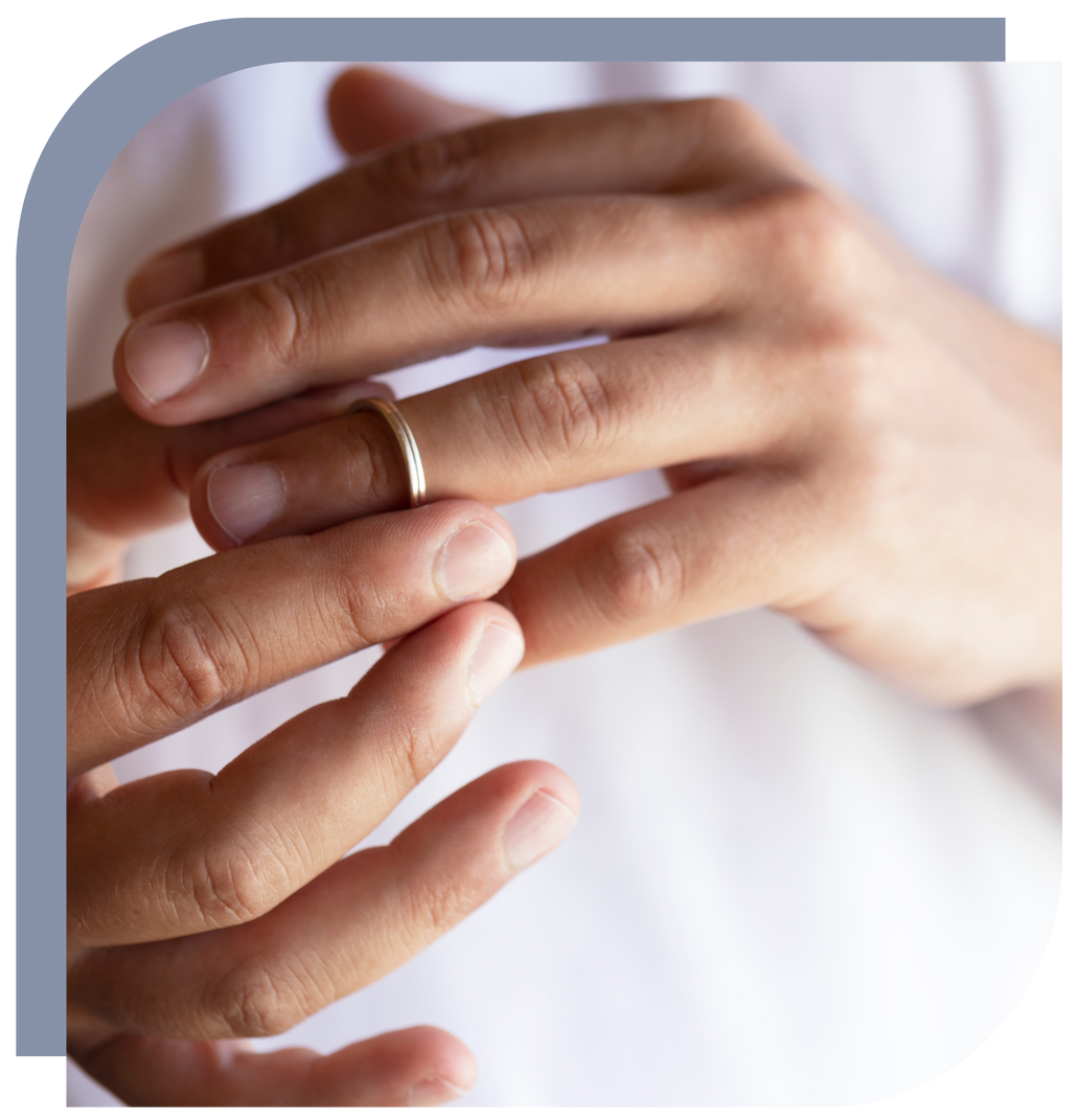 A person wearing a wedding ring on their finger