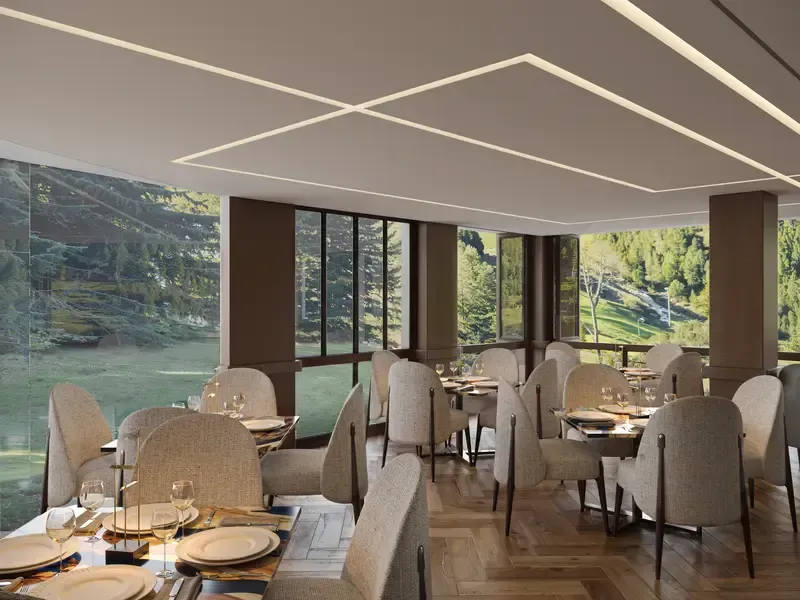 A restaurant with tables and chairs and a view of a lake