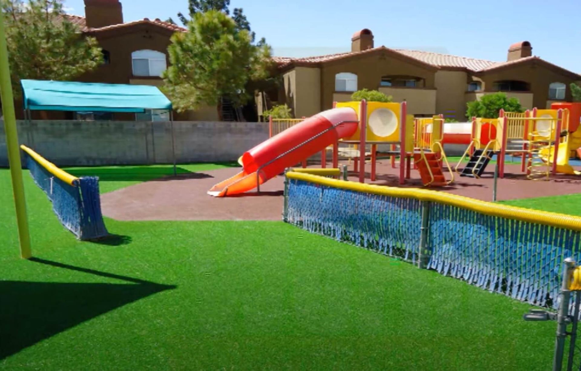A welcoming playground with artificial turf.