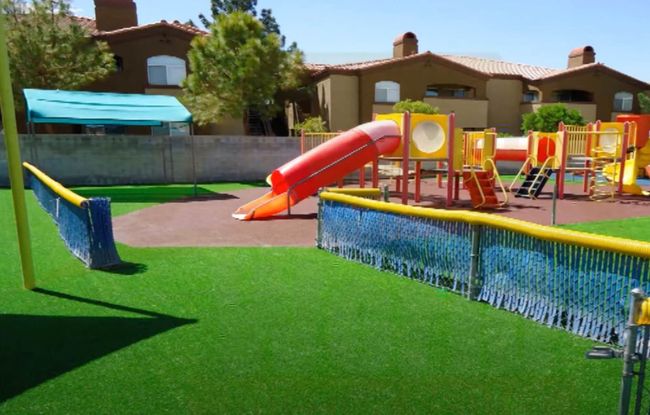 A welcoming playground with artificial turf.