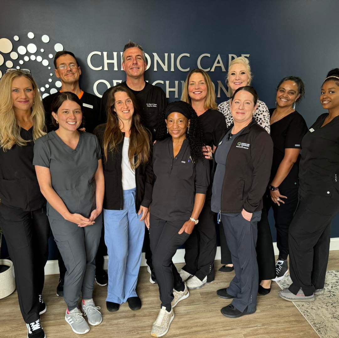 A group of people standing in front of a sign that says chronic care