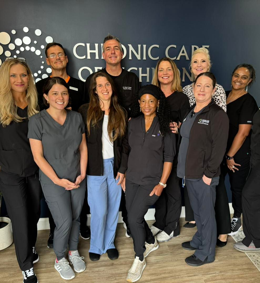A group of people standing in front of a sign that says chronic care