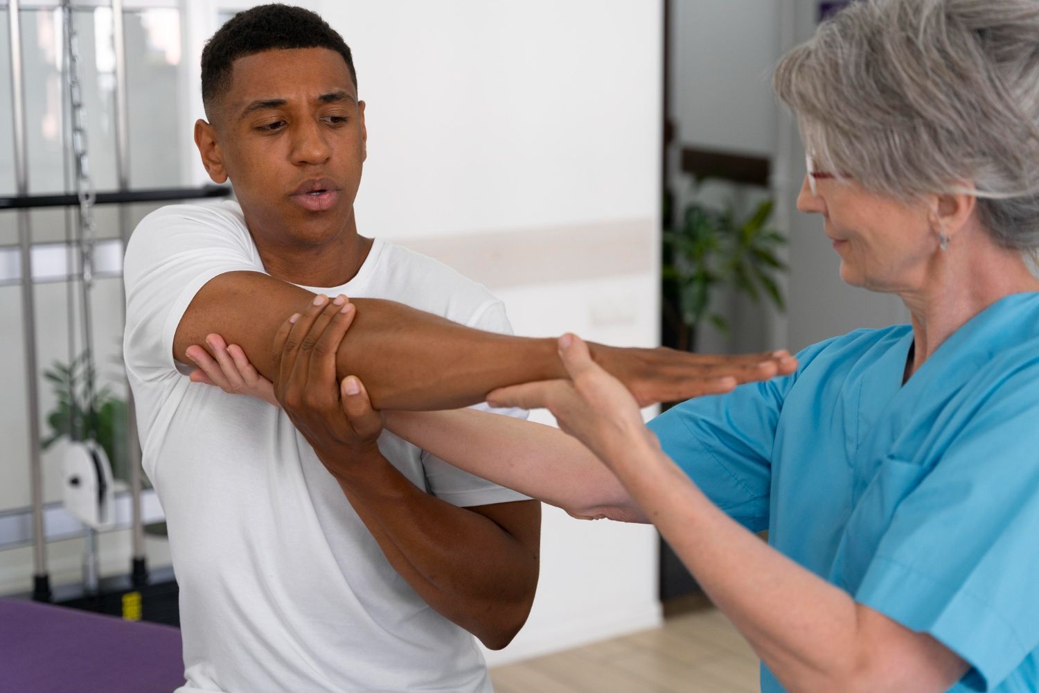 A man is being examined by a nurse in a hospital.