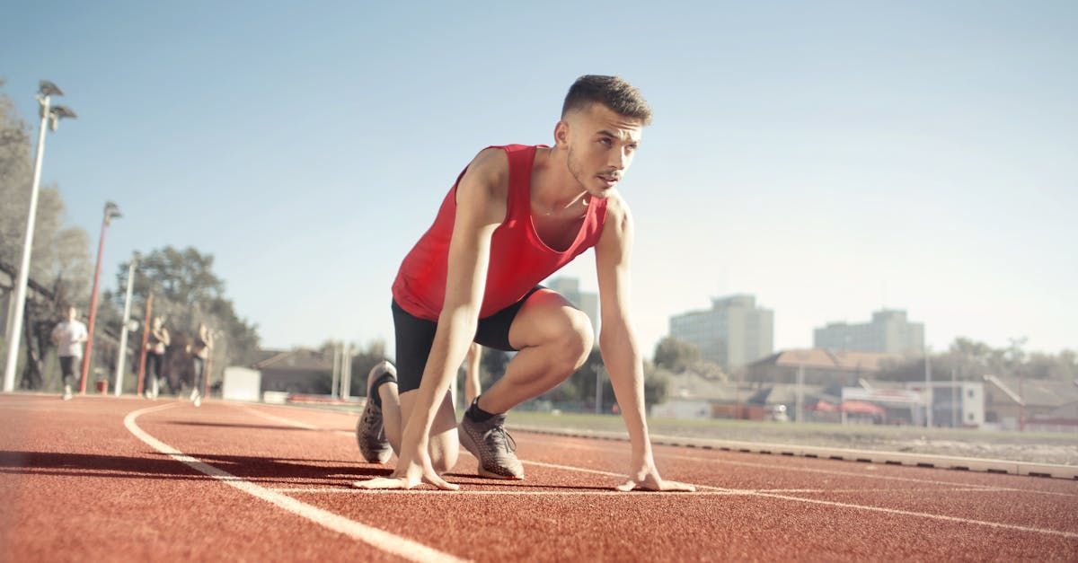 A man is getting ready to run on a track.
