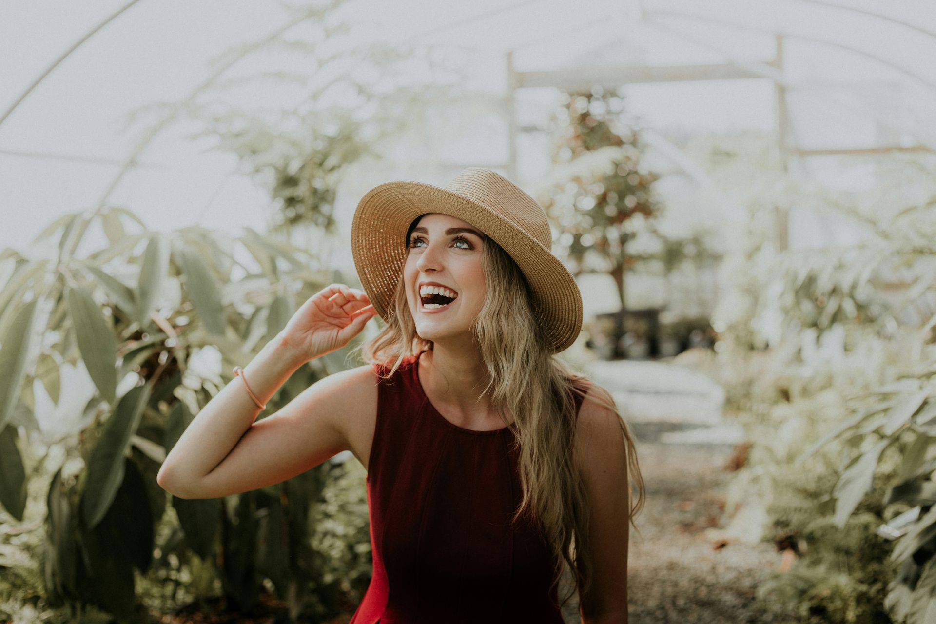 a woman with a sun hat smiling