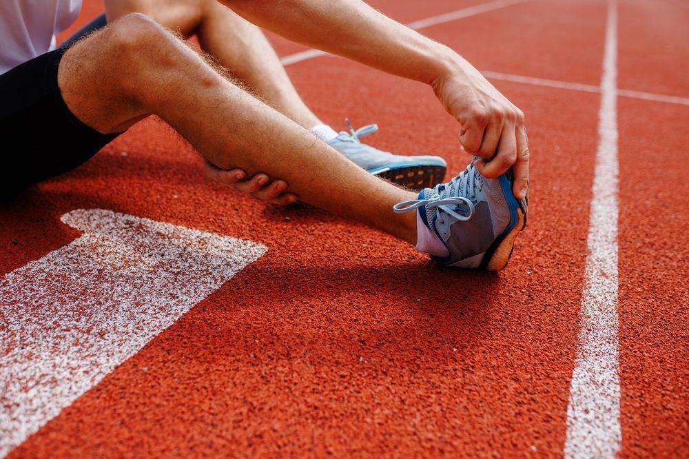 athlete holding their foot