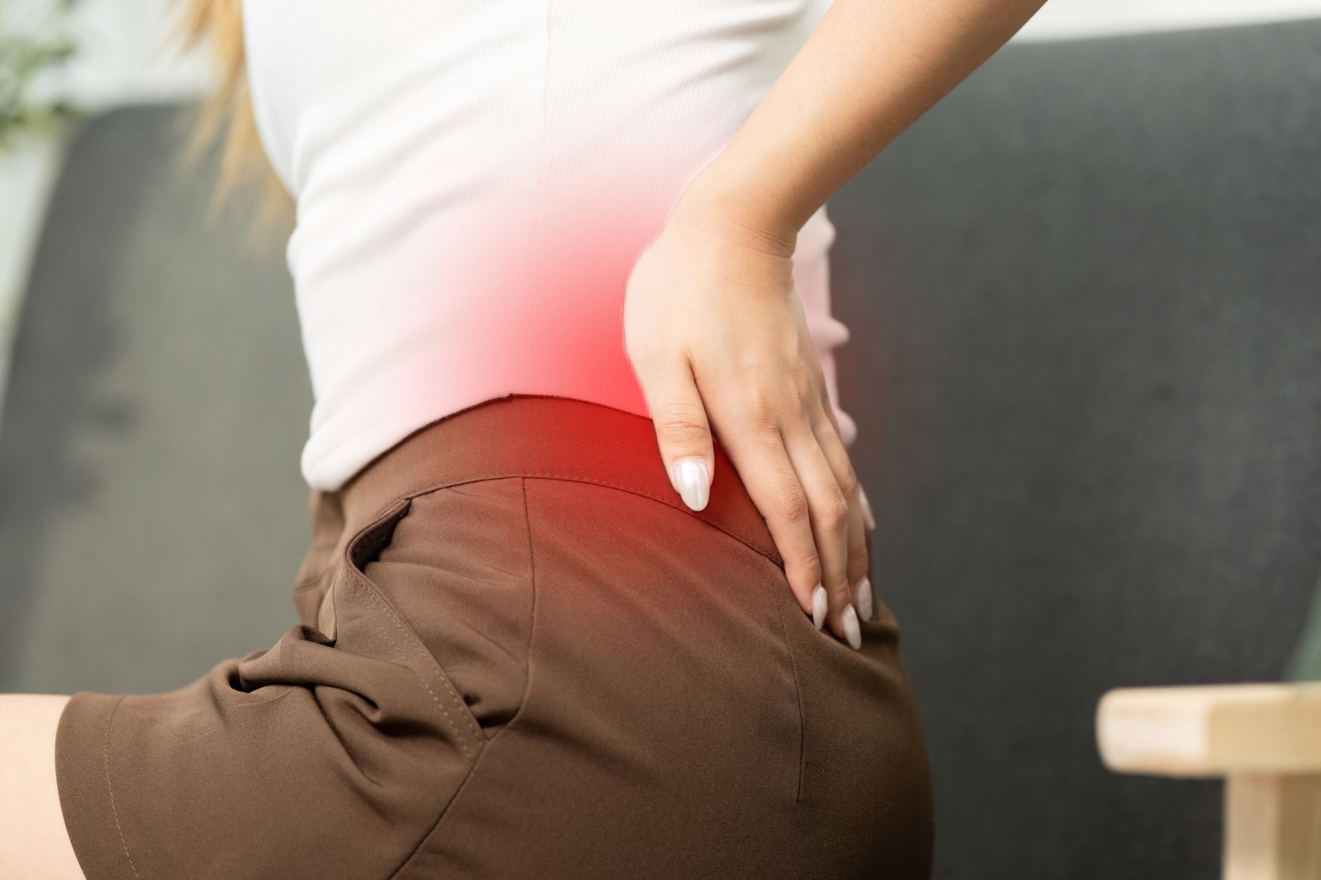 woman holding her lower back in pain