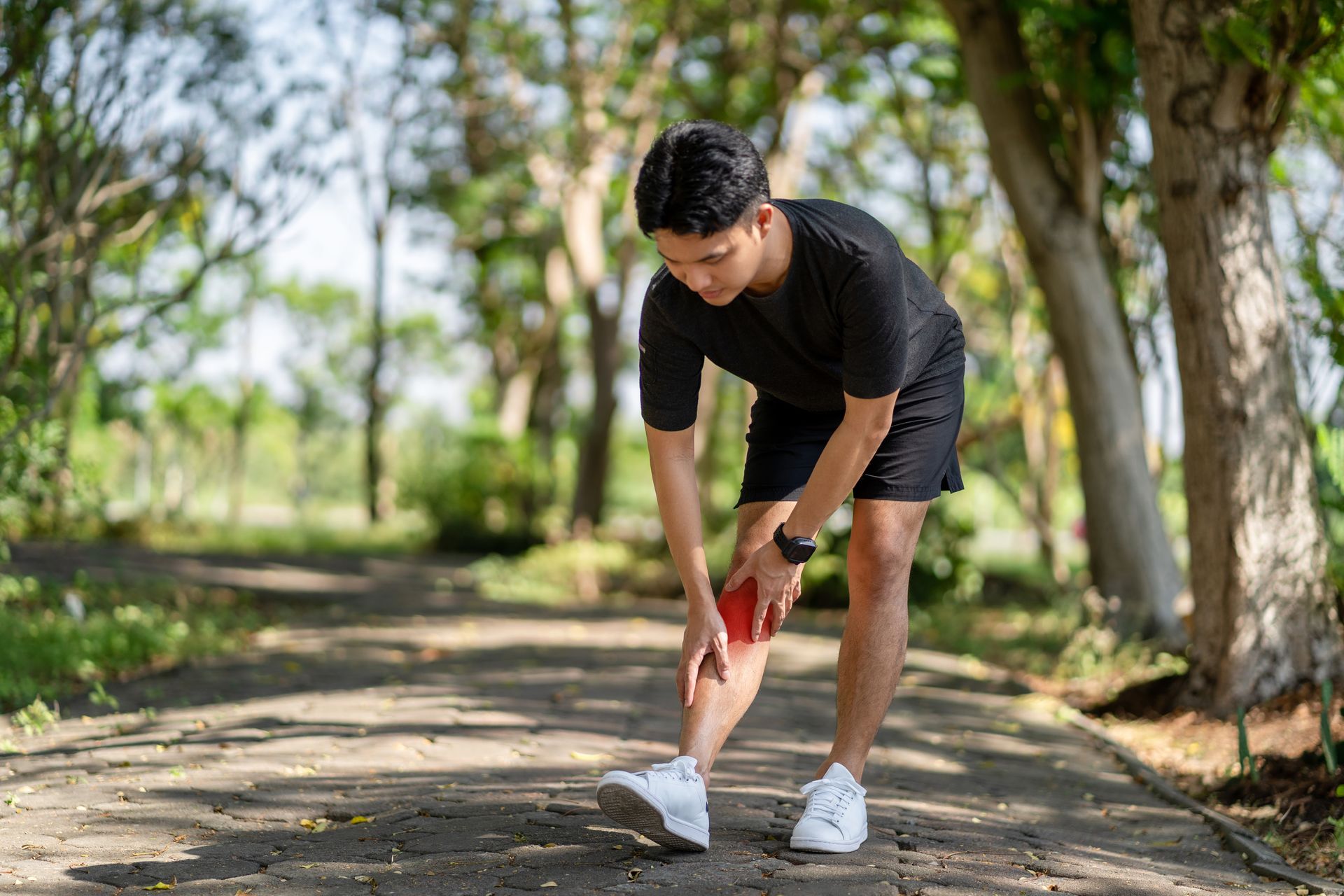 a runner holding his leg in pain