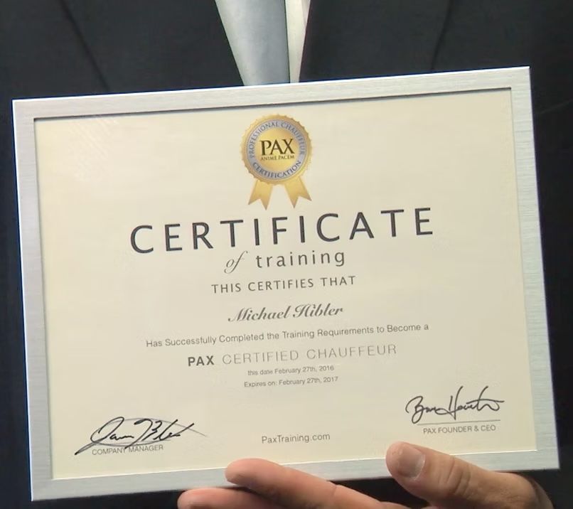 Certificate of training in a silver frame, declaring Michael Hibber a PAX Certified Chauffeur.