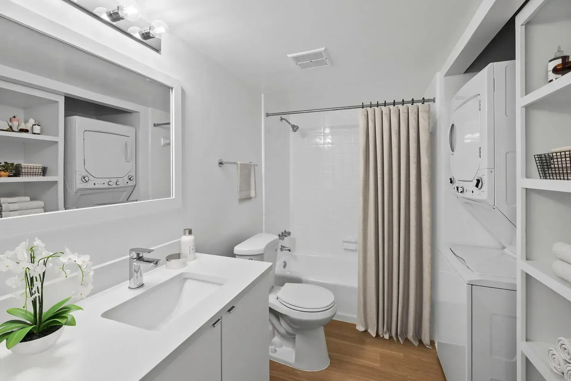 Hale Nani apartment bathroom with sink, mirror, and toilet.