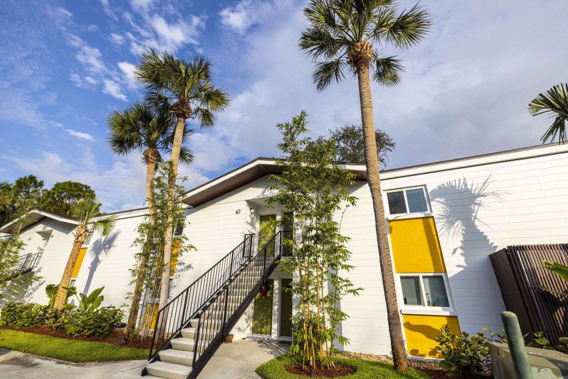 Hale Nani apartment exterior stairs and palm trees.