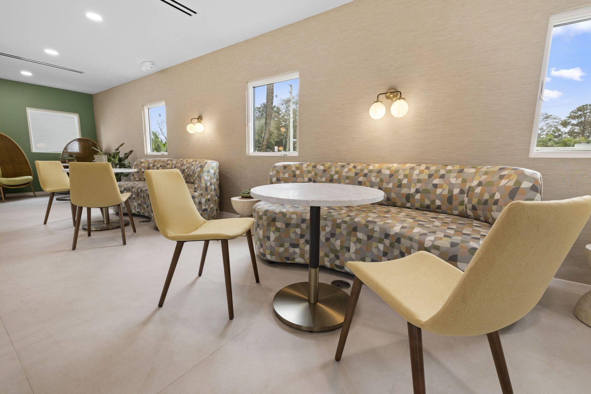 Hale Nani apartment clubhouse with sofa, chairs, and tables.