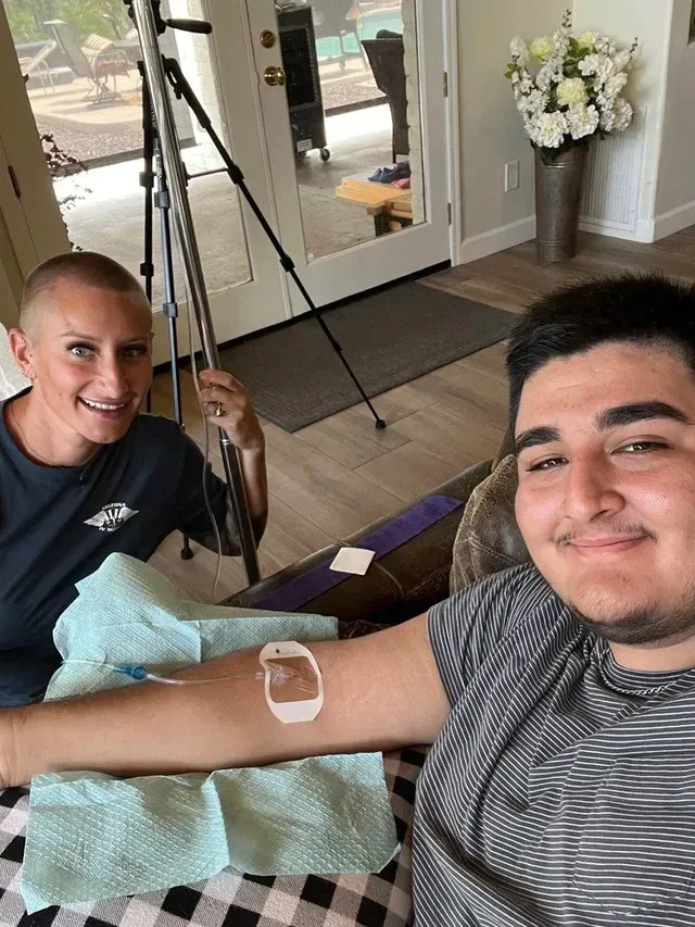 A man and a woman are sitting next to each other in a living room.