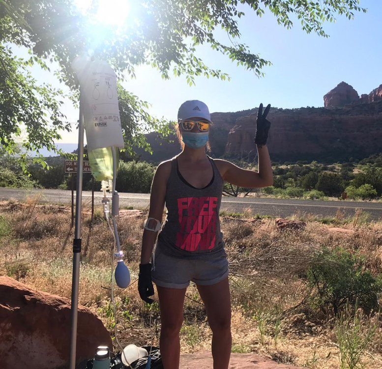 A woman wearing a tank top that says fluff on it