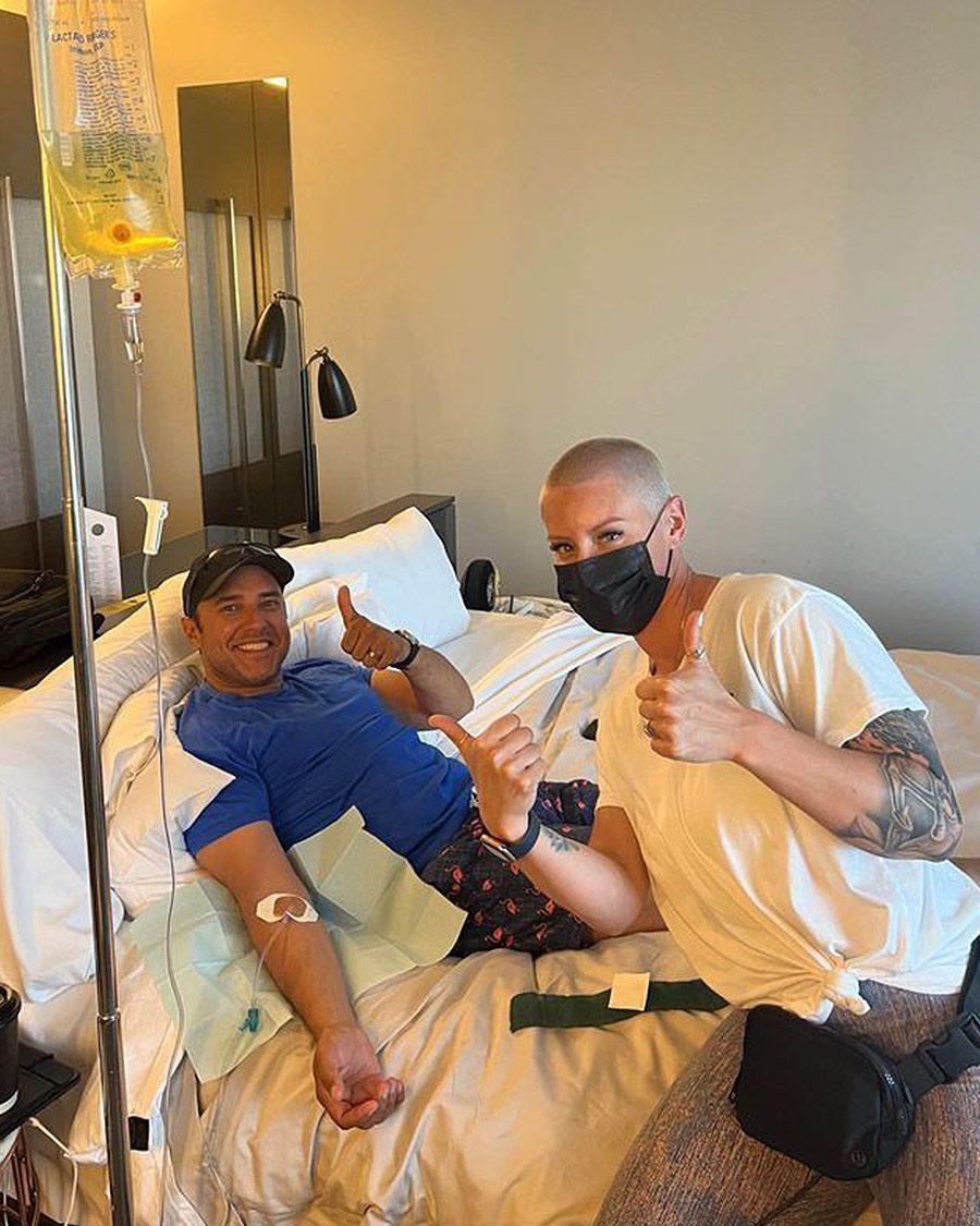 Mobile IV therapy service for travel or hangover recovery in a hotel room, showing two happy clients/patient and attendant.