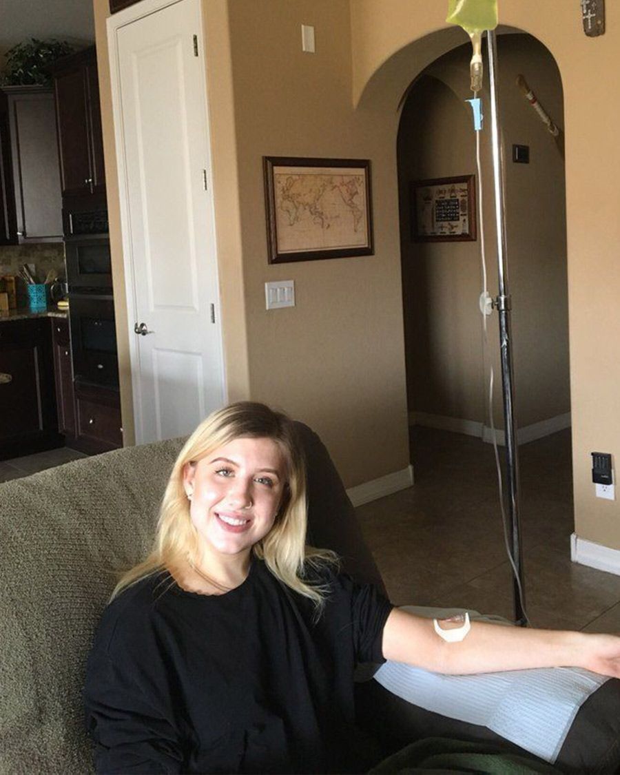 At-home IV hydration or vitamin infusion service for wellness, featuring a young female client.