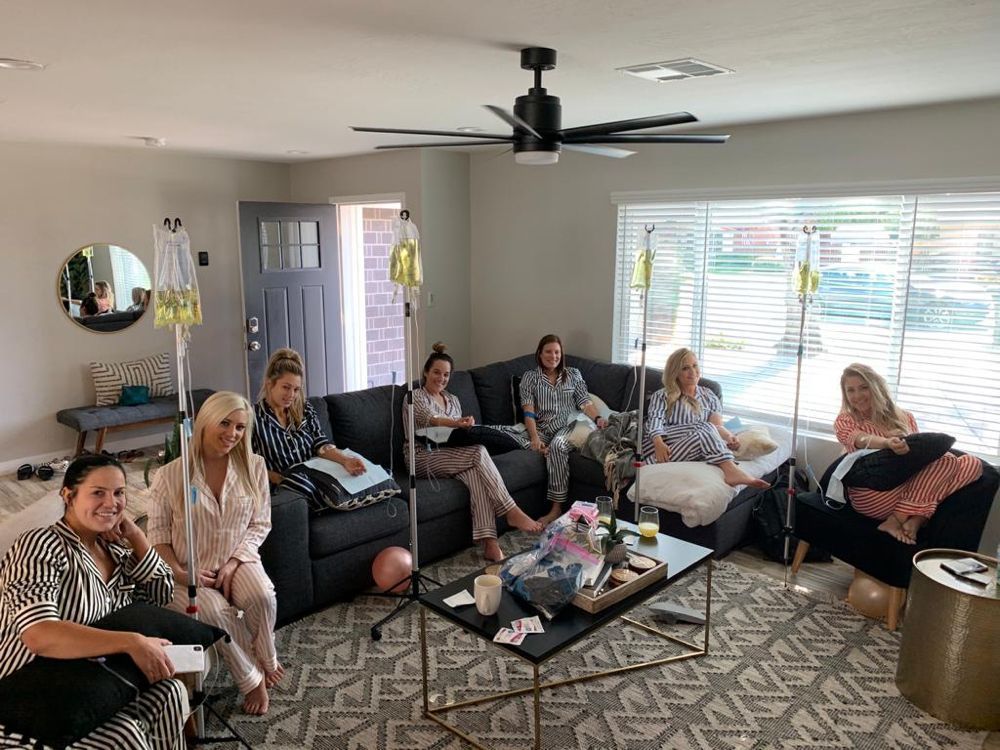 A group of women are sitting on couches in a living room.