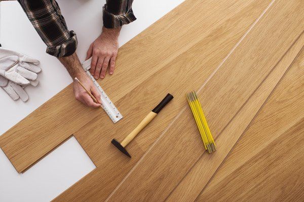 person repairing wood floor