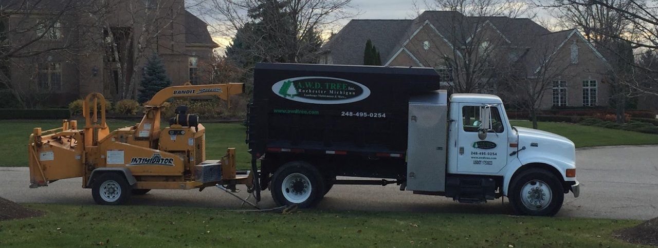 Truck and Chipper Machine — Romeo, MI — AWD Tree Service, Inc.