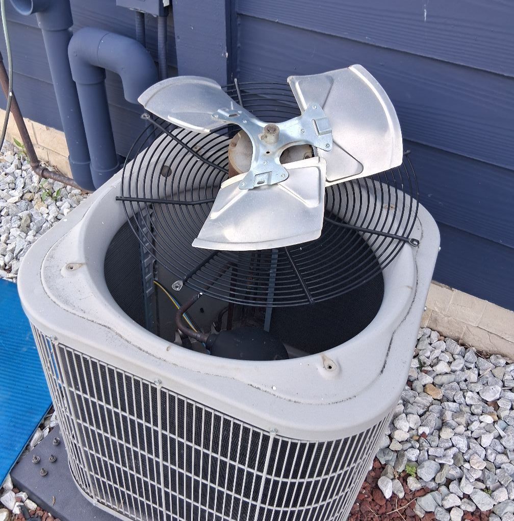 An air conditioner with a fan on top of it