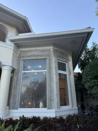 A house with a large window on the side of it.