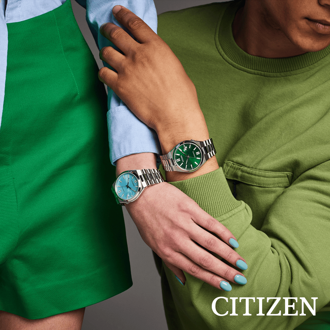 A man and a woman wearing citizen watches are hugging each other.