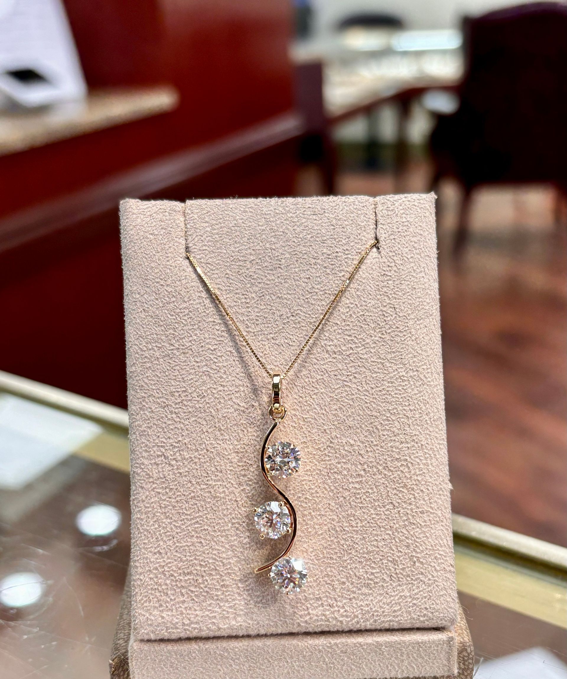 A necklace is on display on a table in a store.