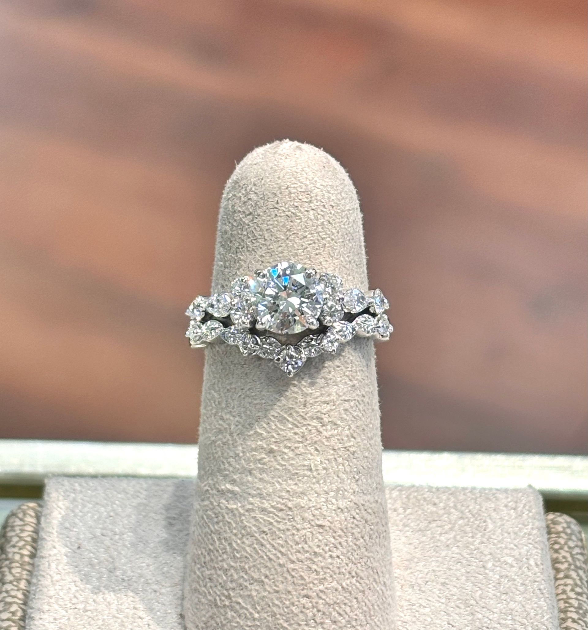 A diamond ring is sitting on a ring holder.