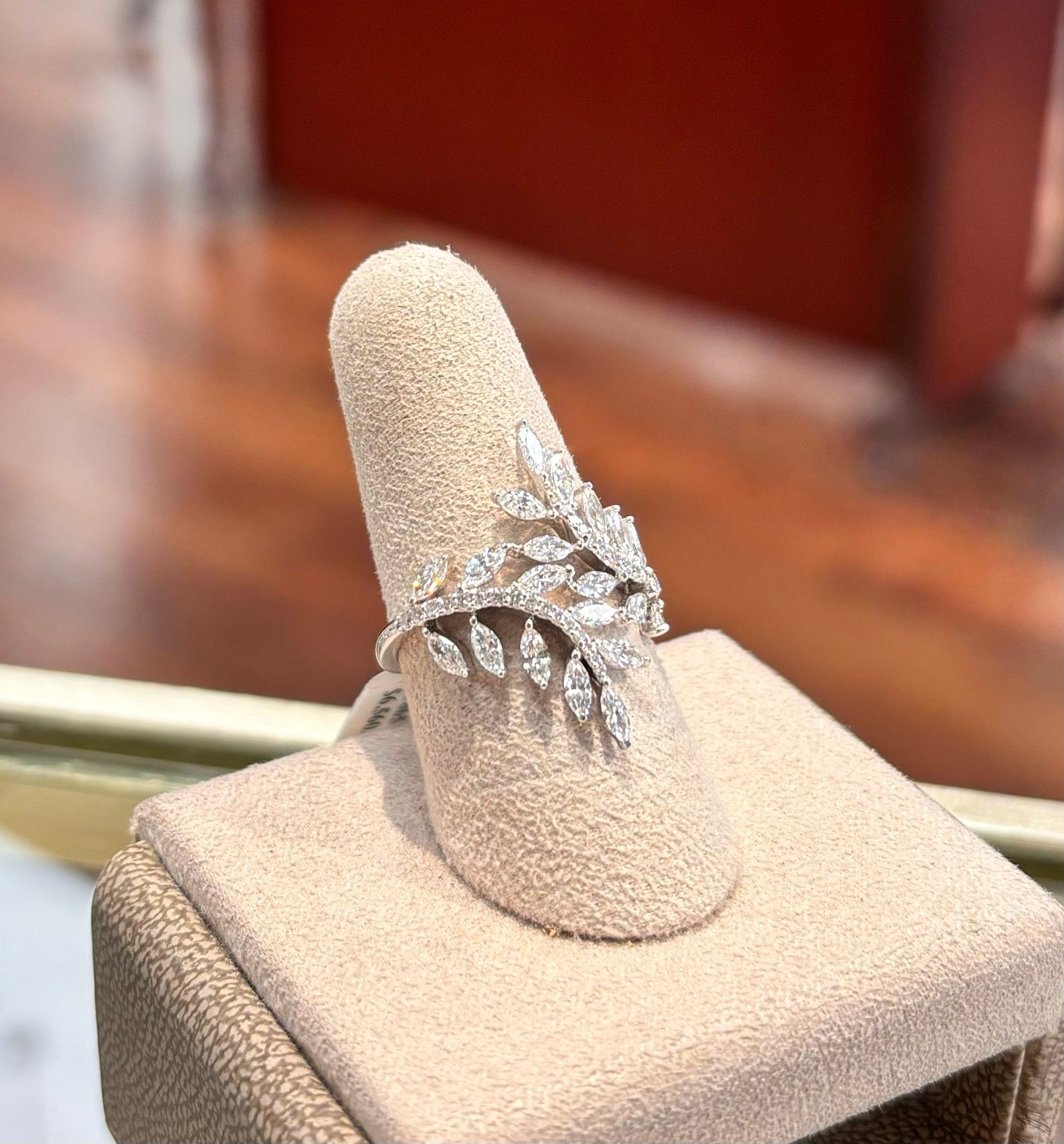 A diamond ring is sitting on a ring holder