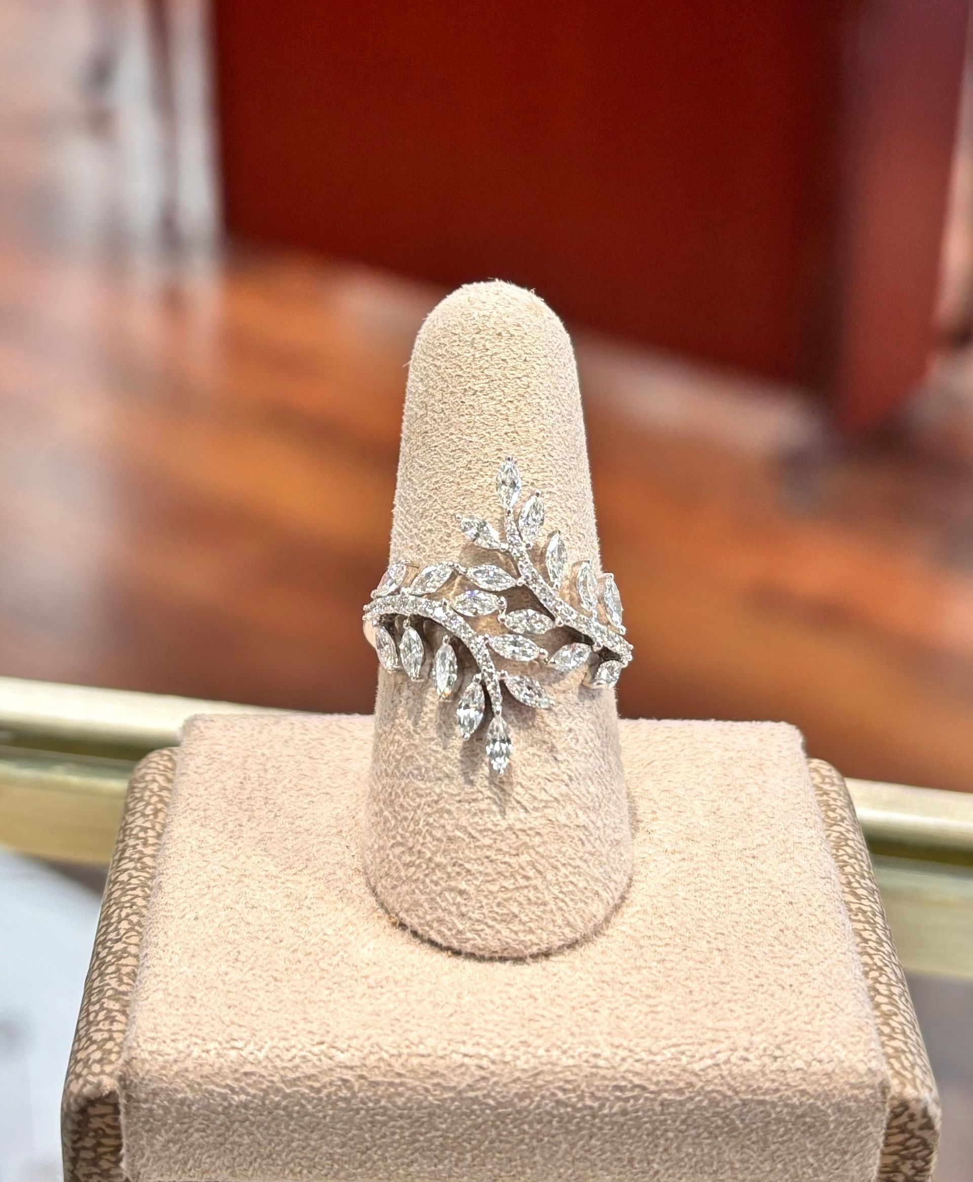 A diamond ring is sitting on a display stand
