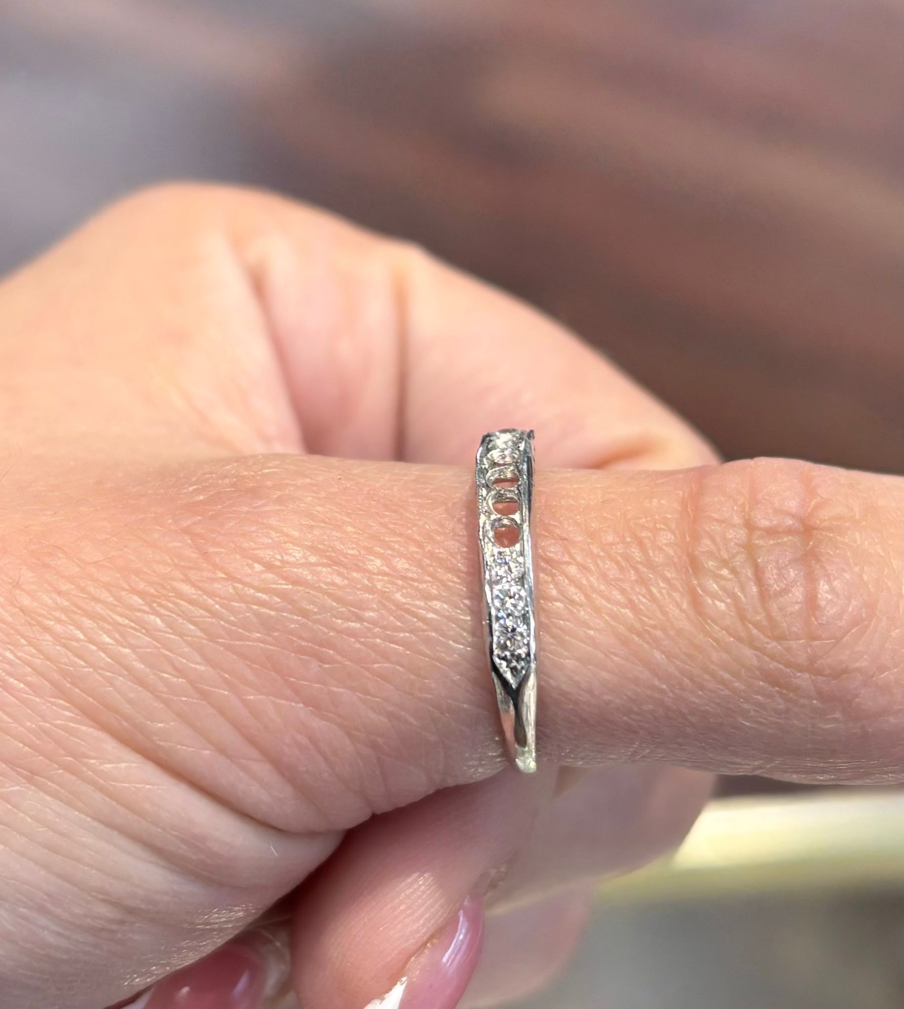 A person is holding a ring on their finger.