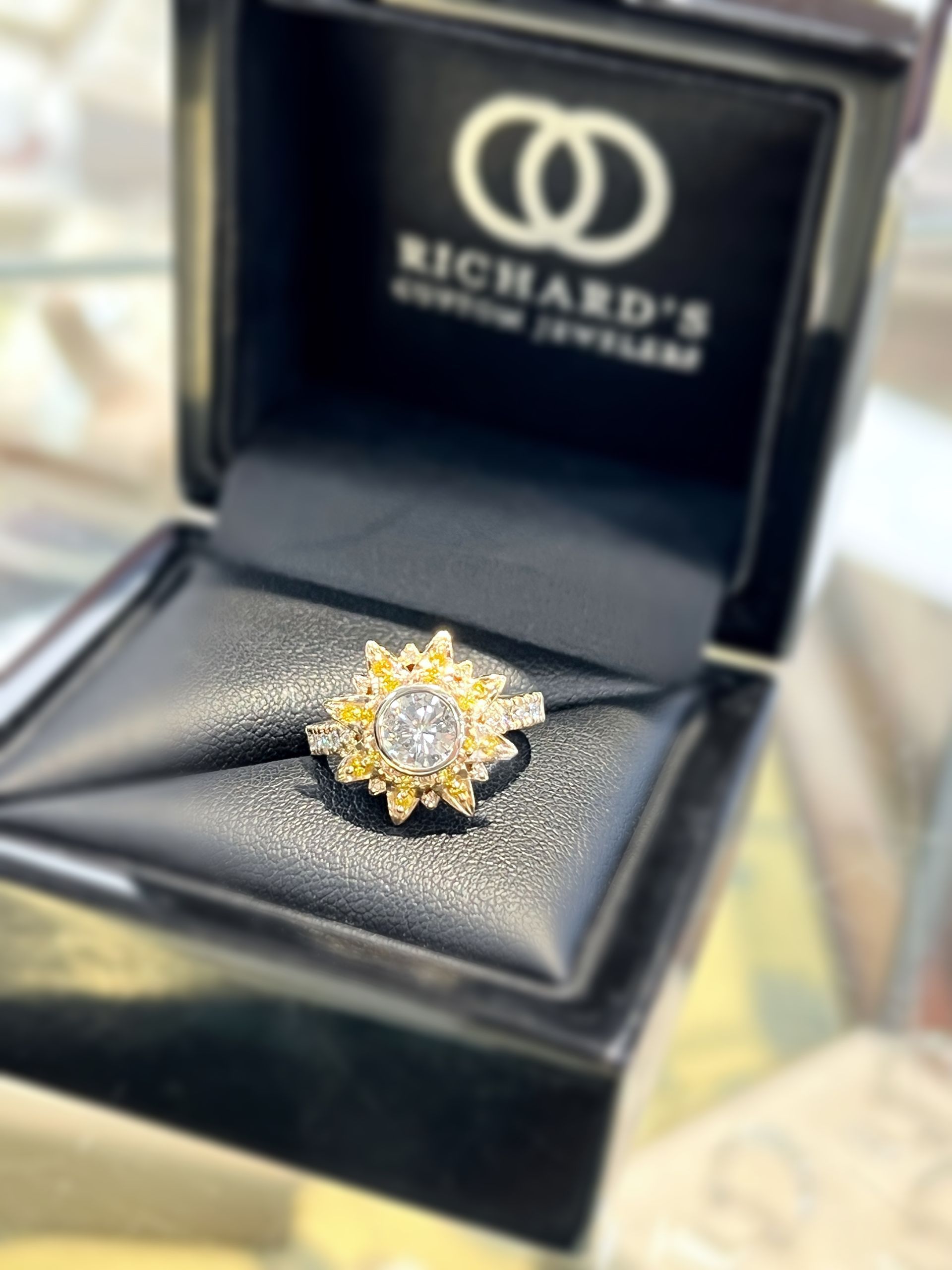 A ring in a box that says richard 's on it