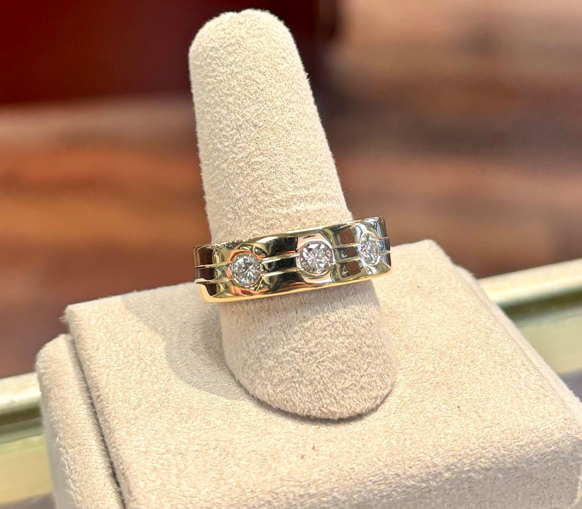 A close up of a ring on a finger on a display case.