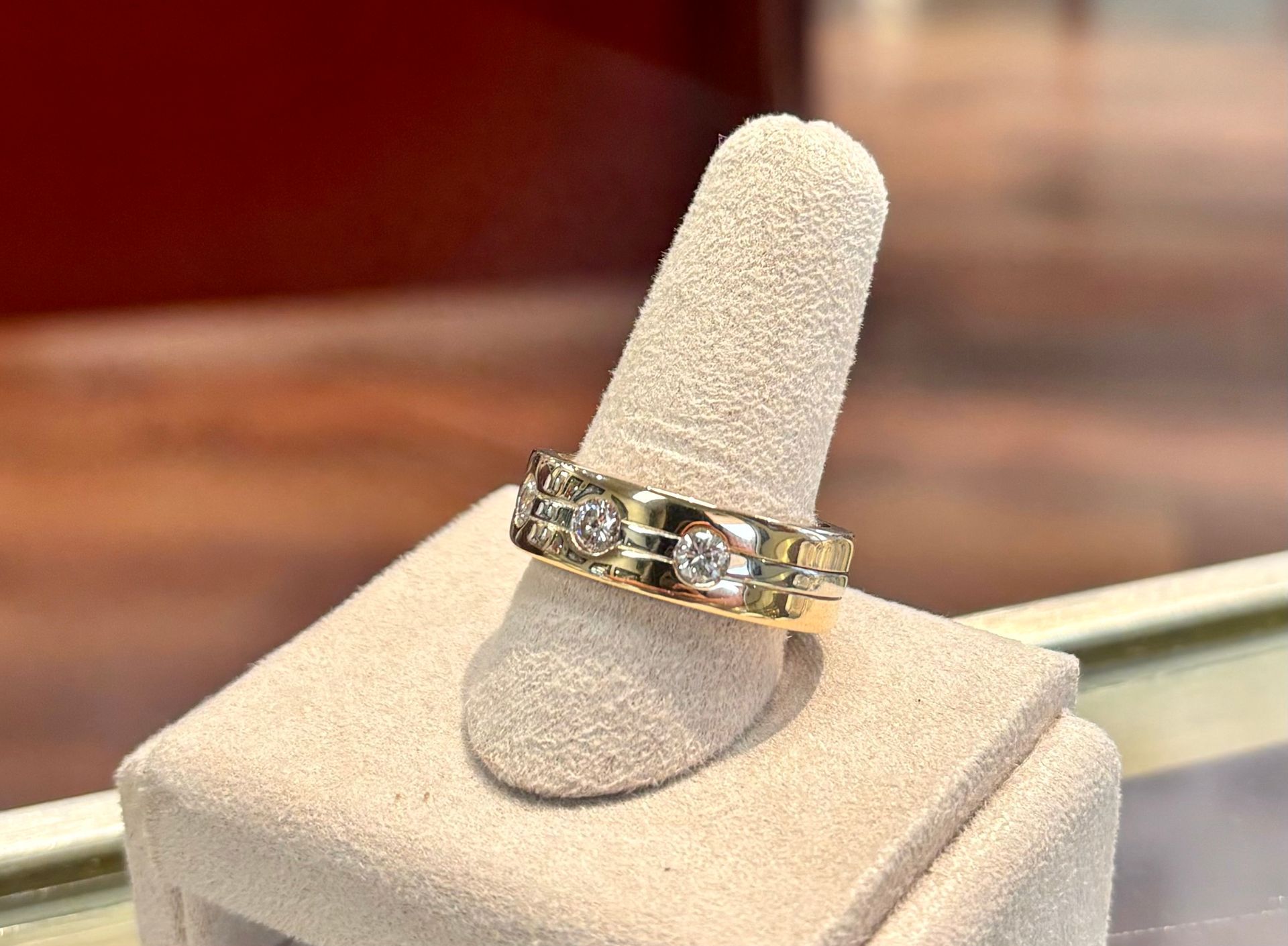 A ring is sitting on a display stand on a finger.
