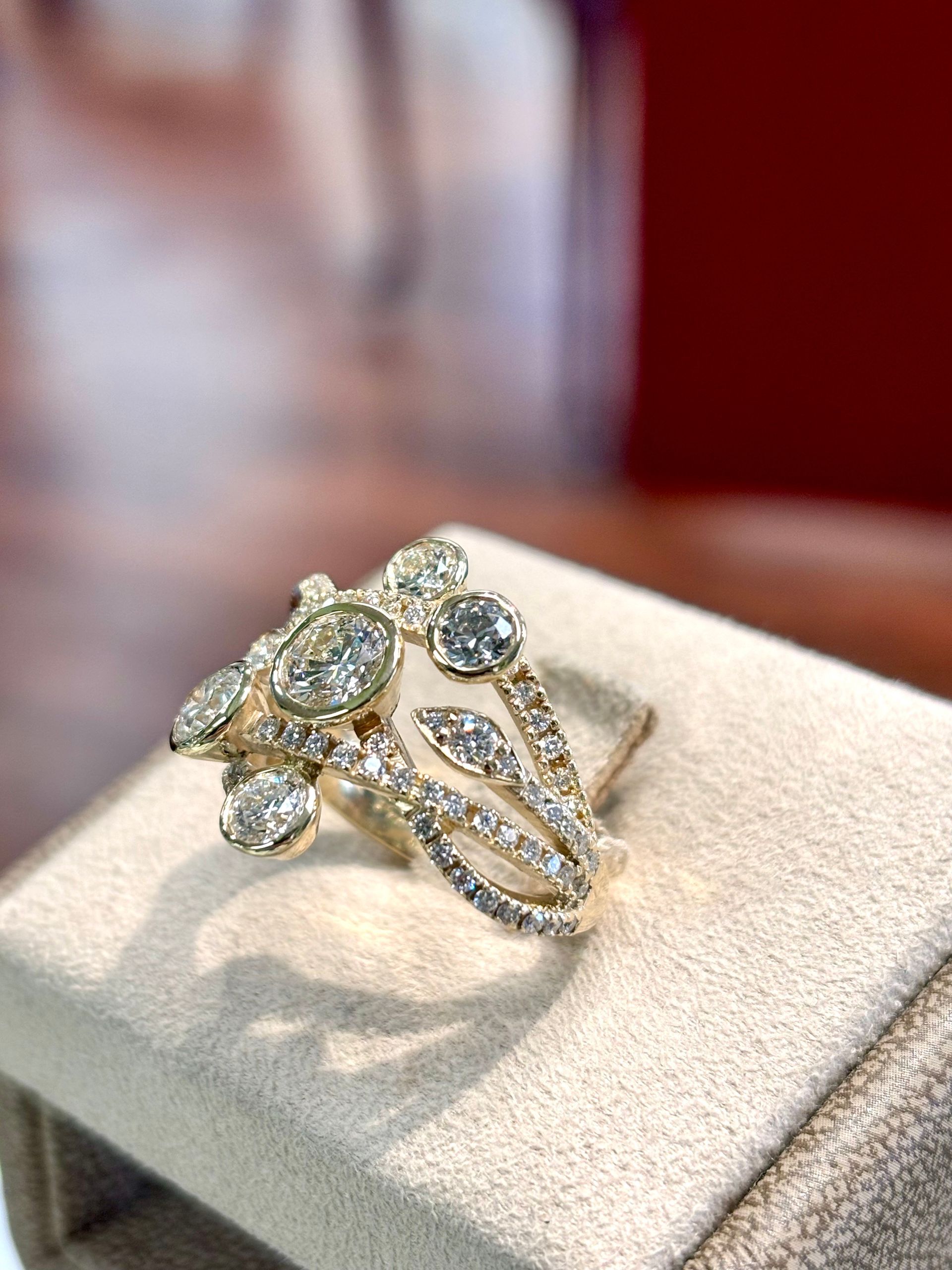 A close up of a ring with diamonds on a table.