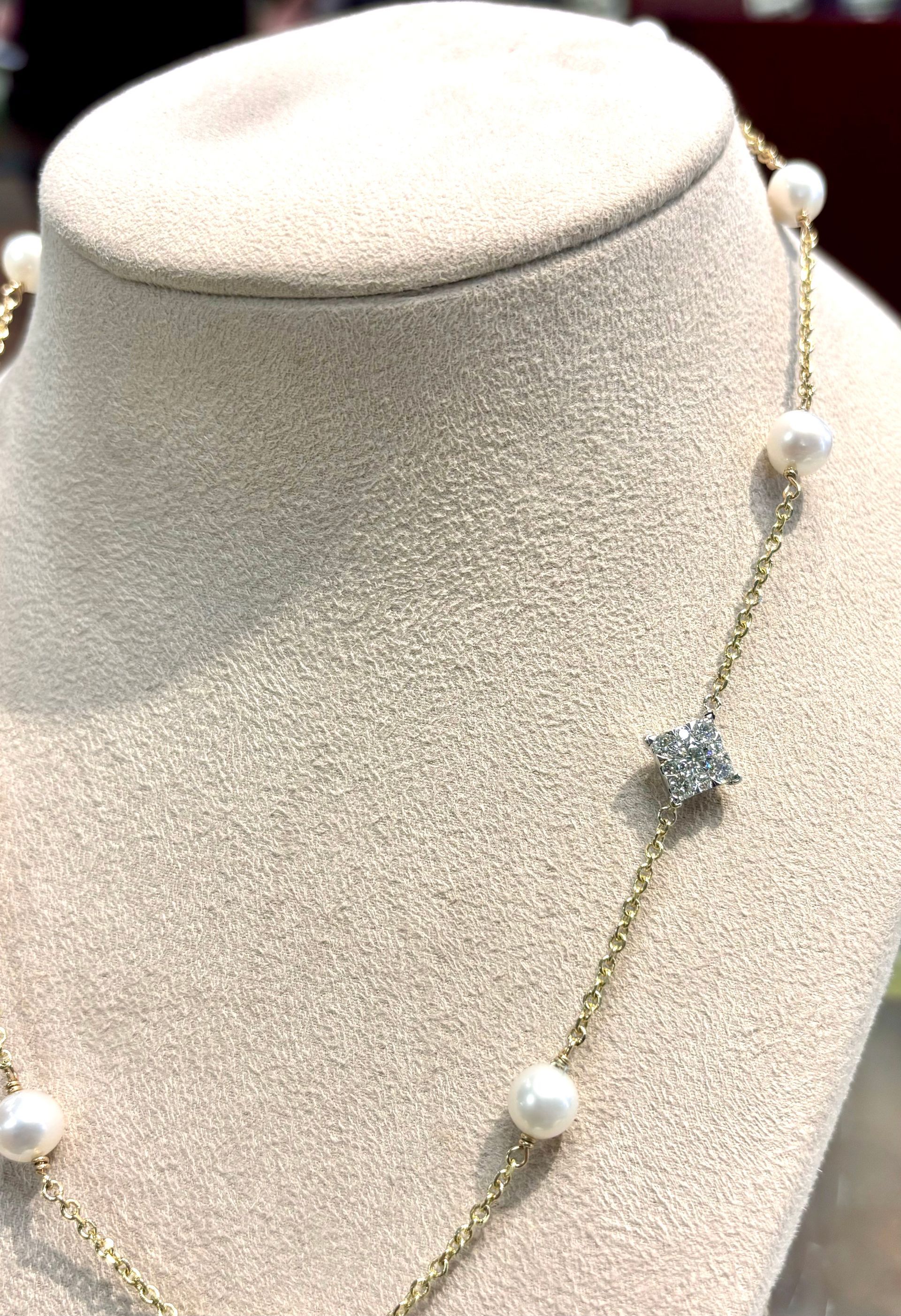 A close up of a necklace with pearls and diamonds on a mannequin.