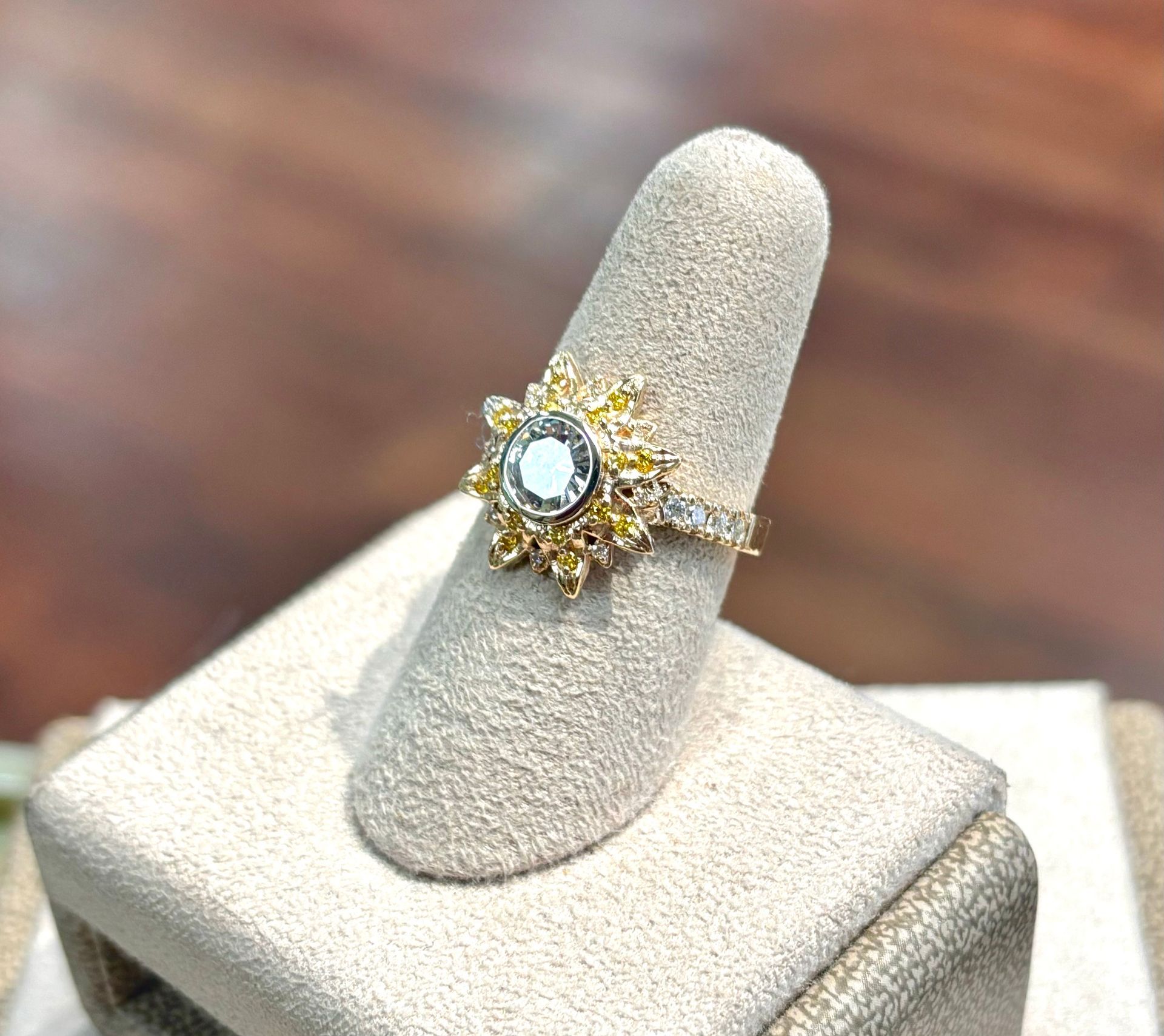 A ring is sitting on a ring holder on a table.