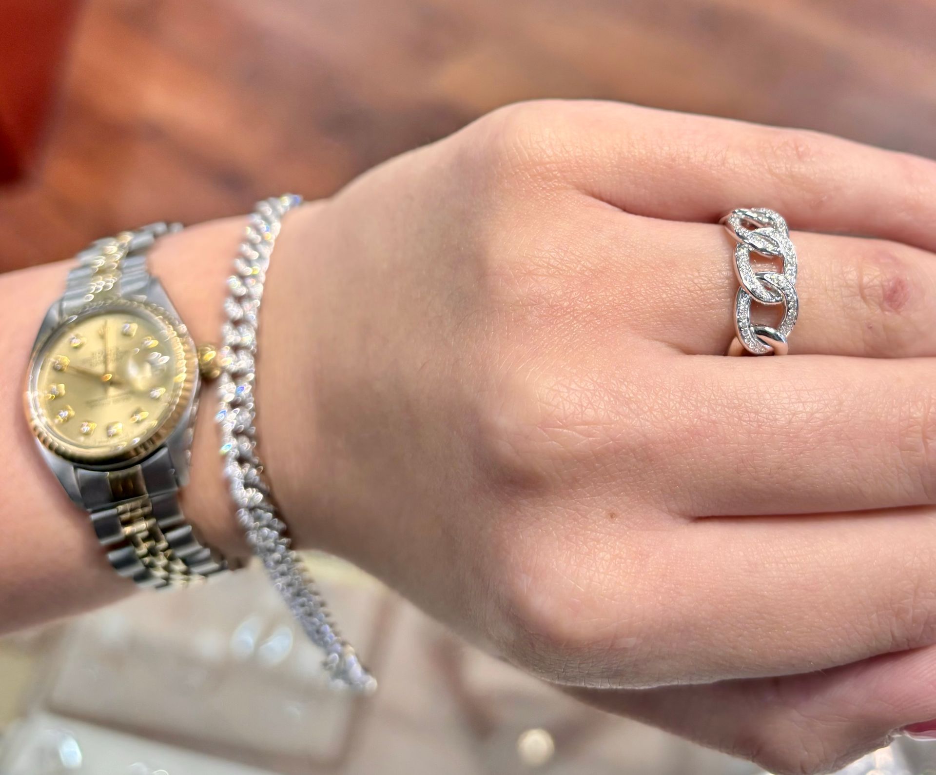A woman wearing a watch and a ring on her wrist