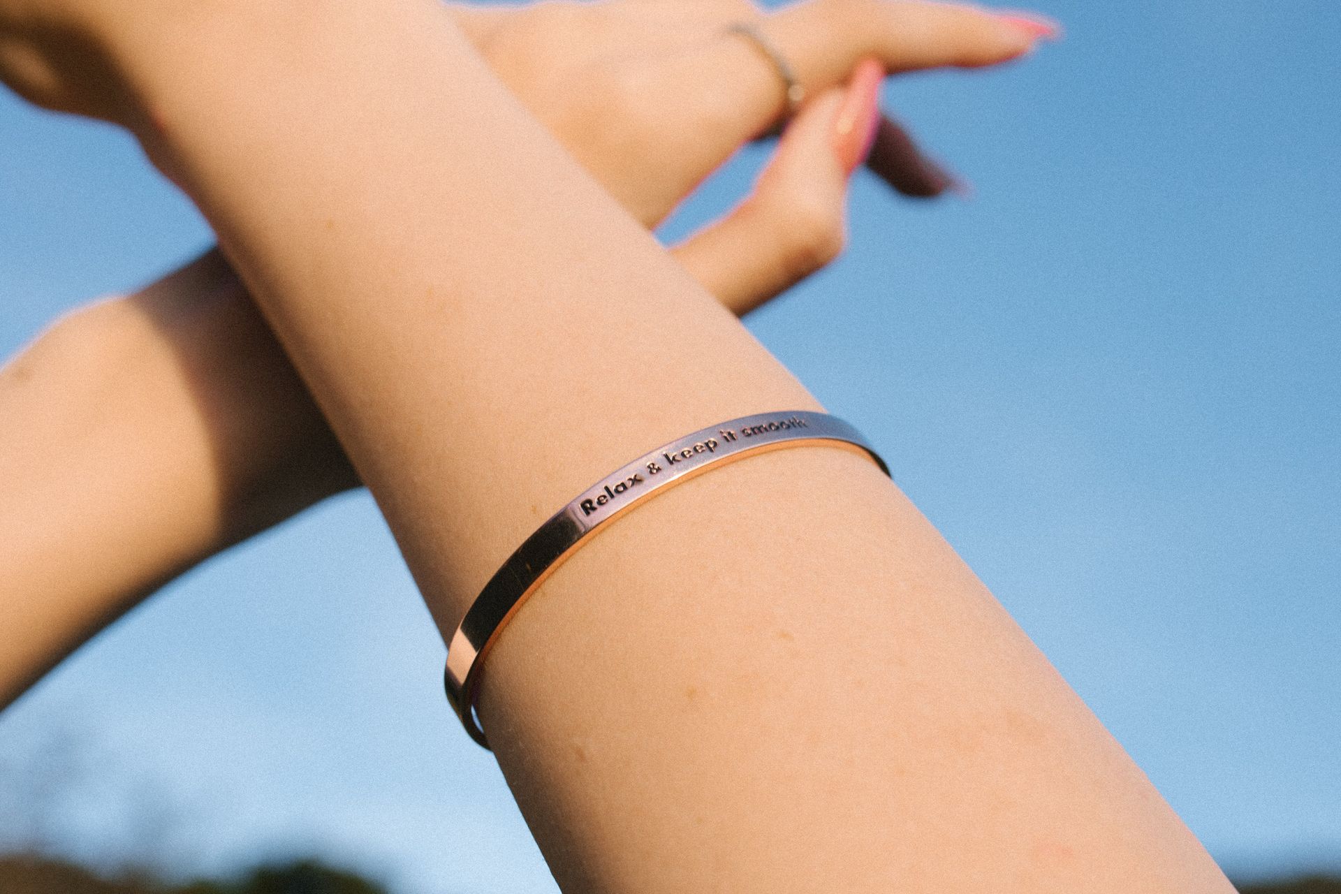 A close up of a woman 's arm with a bracelet on it