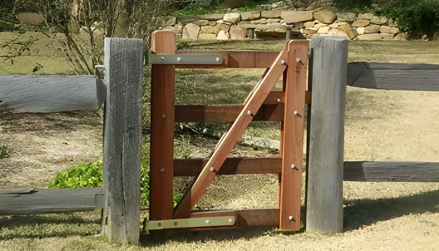 A Wooden Gate is Surrounded by a Wooden Fence — Osborne Fencing in Bundanoon, NSW