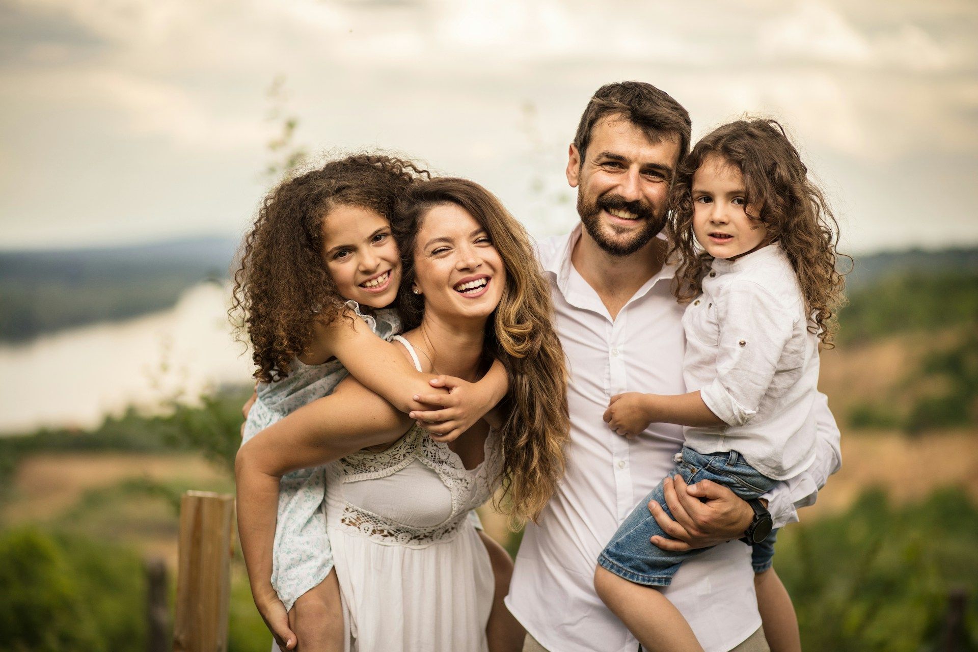 A family is posing for a picture together in a field.